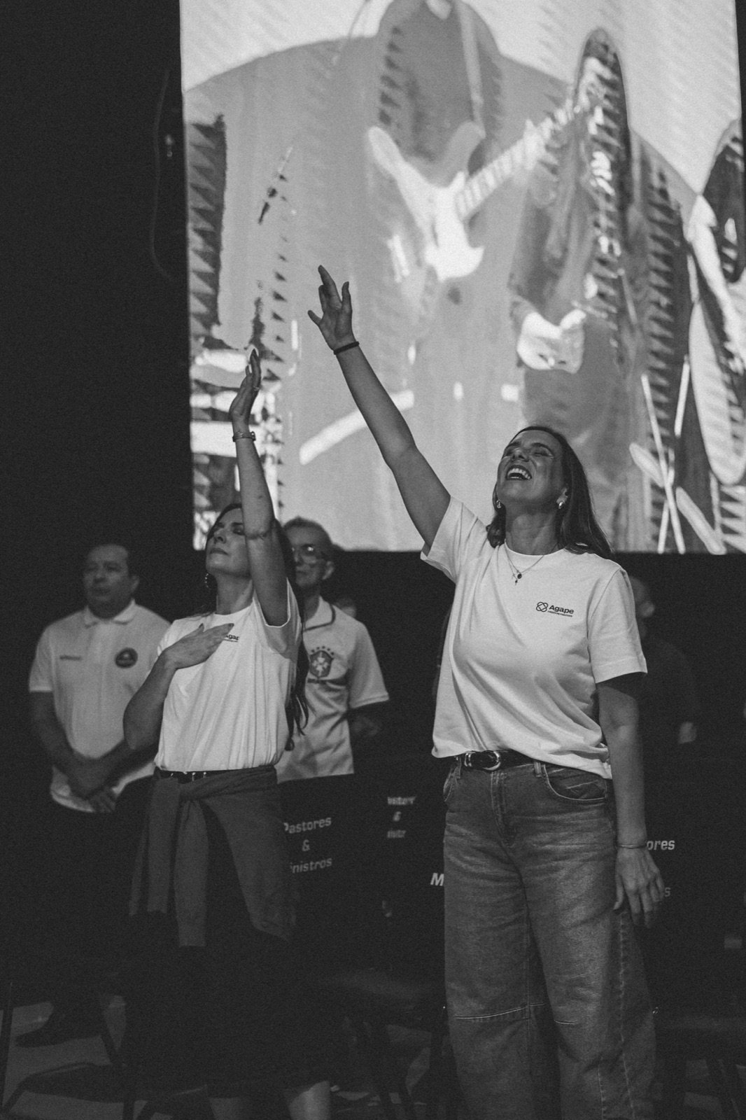 Two believers worshipping together on stage